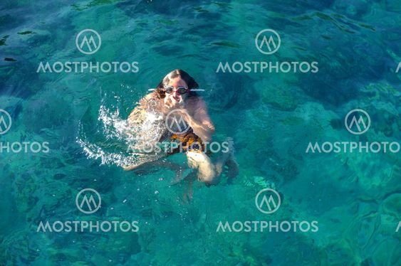 Young teenager playing in the sea