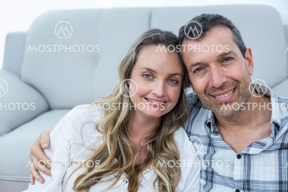 Pregnant couple sitting floor
