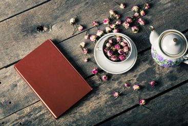 Vintage teapot and cup with blooming tea flowers on...