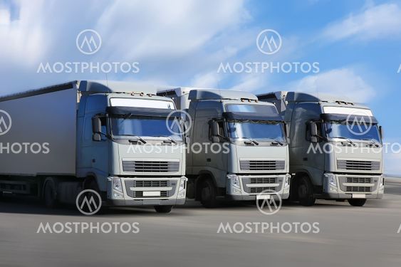 three trucks go on highway