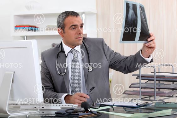 Doctor examining x-ray of hand