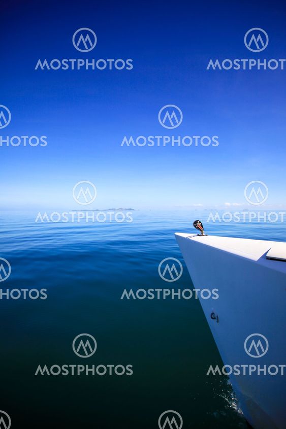 Bow of a sailing boat in calm blue sea