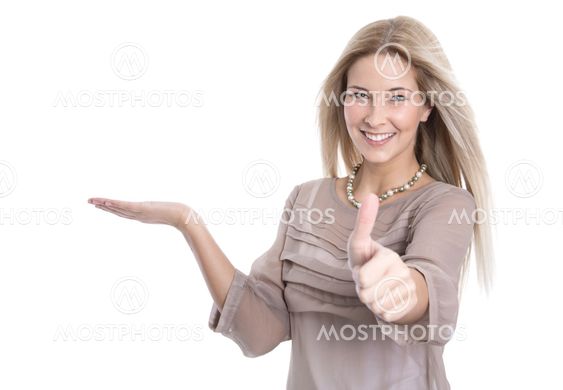 Smiling attractive woman presenting and thumb up -...
