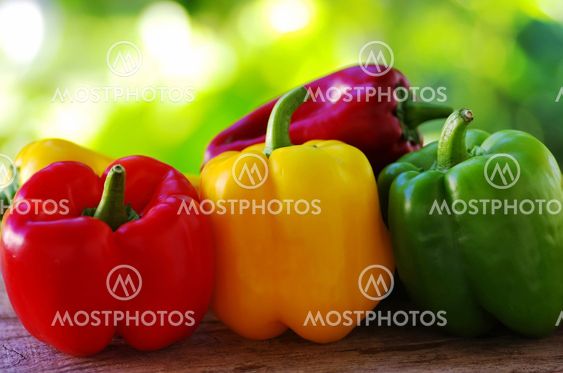 red, yellow and green pepper on green background