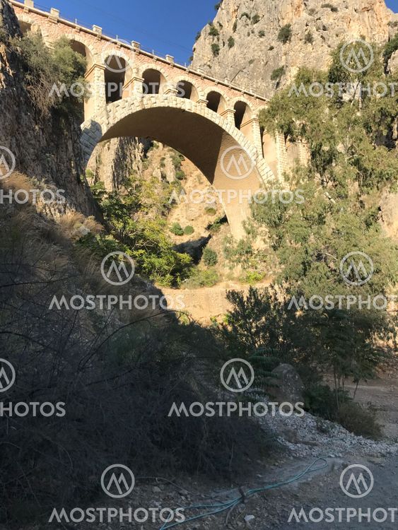Old bridge between two mountains