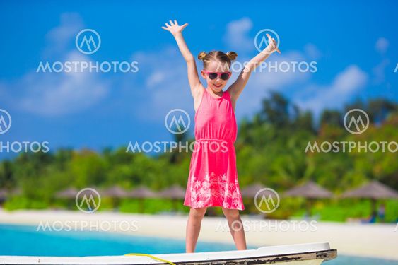 Adorable little girl at beach during summer vacation