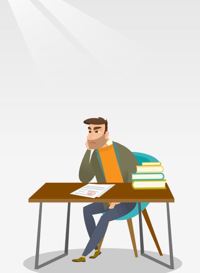Sad student looking at test paper with bad mark.