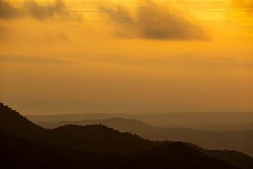 Sunset with stormy cloud sky and dramatic orange...