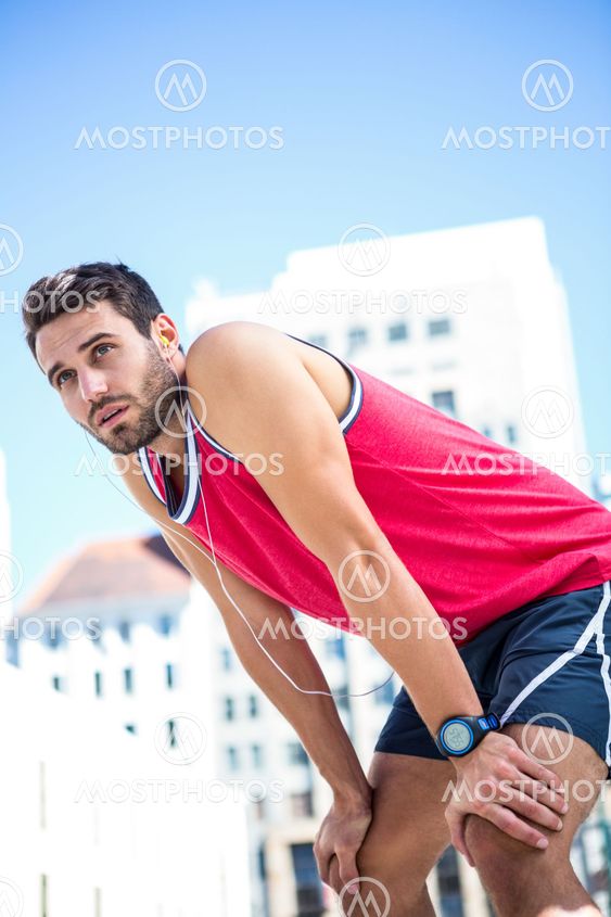Exhausted athlete leaning forward after an effort