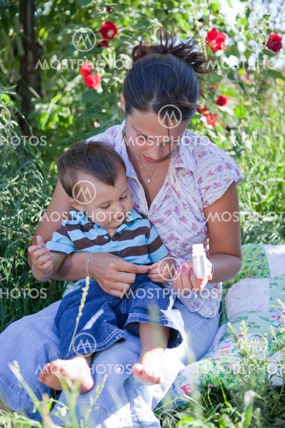 Mother giving homeoptahic medicine to her son
