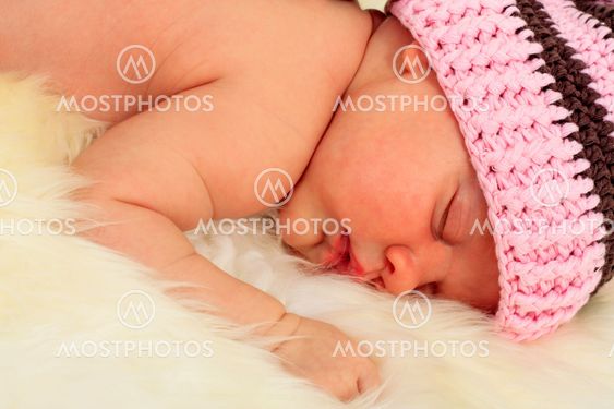 infant sleeping in the white sheep's clothing.