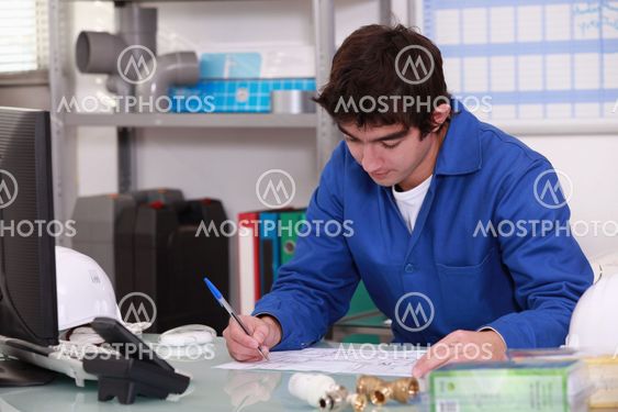 Young apprentice checking stock