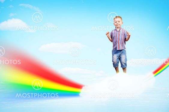 boy jumping on clouds and a rainbow