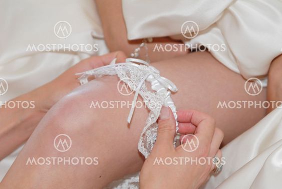Bride dressing for the wedding ceremony