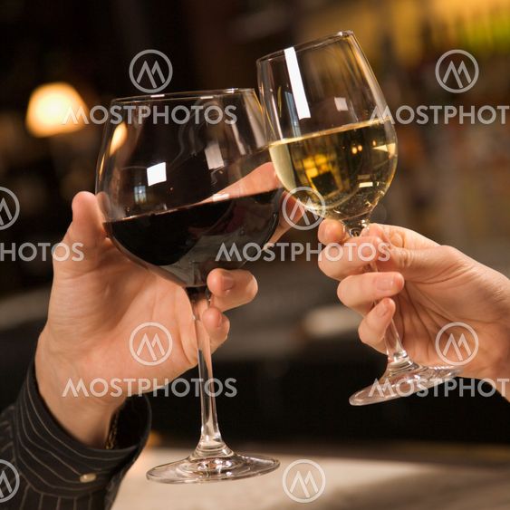 Hands toasting wine.
