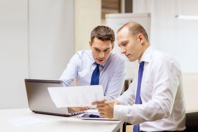 two businessmen having discussion in office