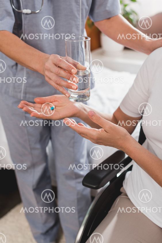 nurse and senior woman in wheelchair