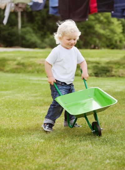 Boy pushing a wheelbarrow