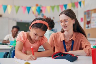 Writing, girl and teacher in classroom, learning and...