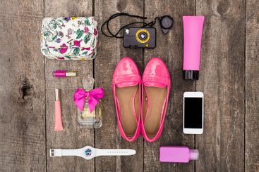 Colorful accessories and essentials arranged on a wooden...
