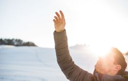 Young man controlling his drone in snowy outdoors. Drone...