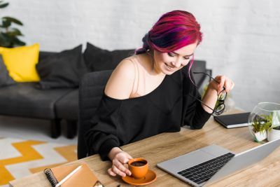 hipster girl with colorful hair sitting behind table,...