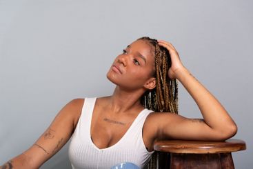 Beautiful brunette woman with braids in her hair,...