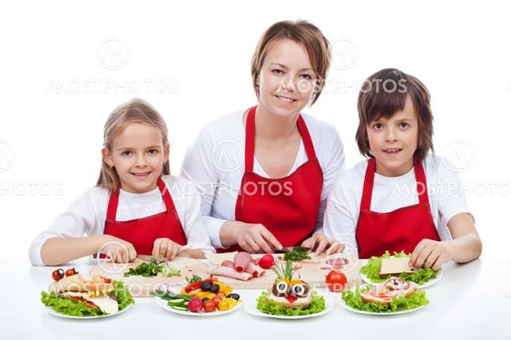 Woman and kids making creative food creature sandwiches