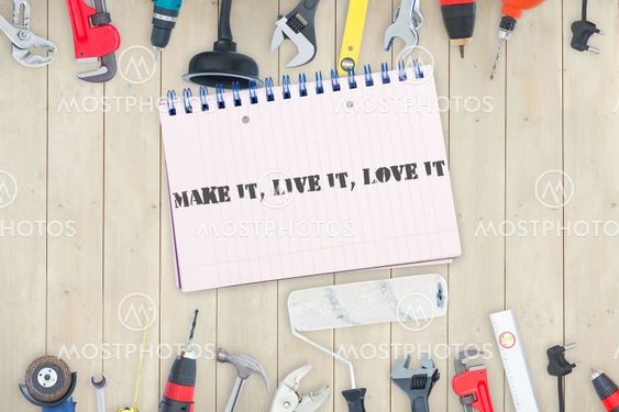 Make it, live it, love it against tools and notepad on wooden background