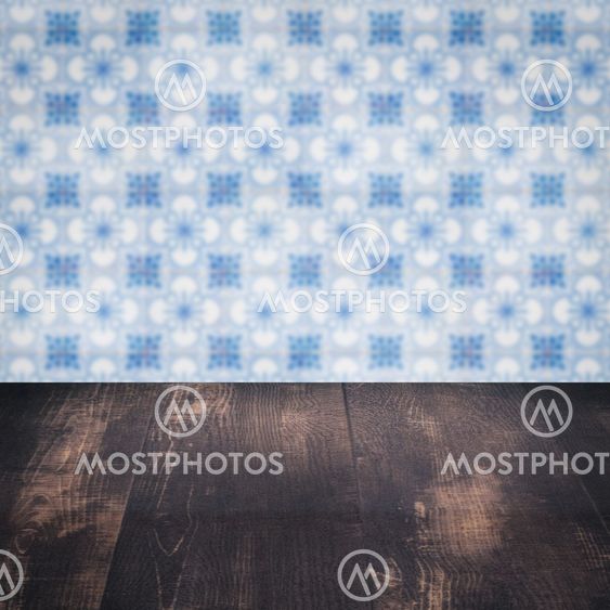 Wood table top and blur vintage ceramic tile pattern wall