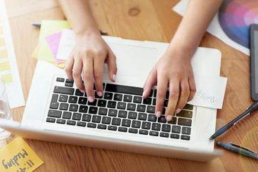 Hands, laptop and typing with color palette at office,...