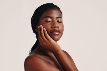Skincare, calm and black woman in studio with natural,...