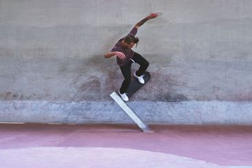 Culture, skateboard and wall with man at park for urban,...