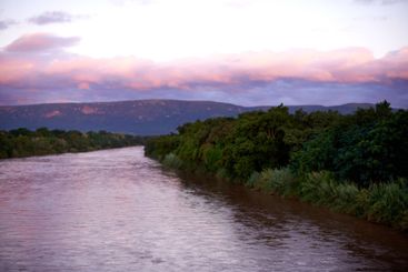 Forest, lake and water outdoor at sunset for travel,...