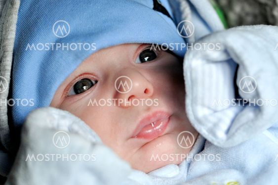 baby boy in blue dress serious look
