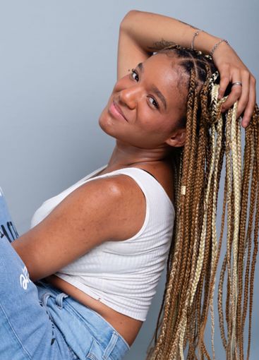 Beautiful brunette woman with braids in her hair,...
