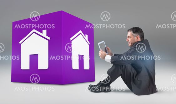 Composite image of mature businessman sitting using tablet