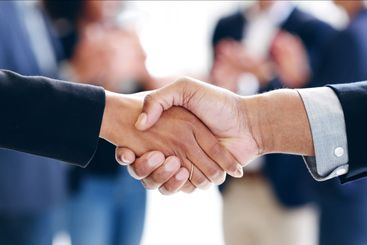 Closeup, business people and handshake in office,...