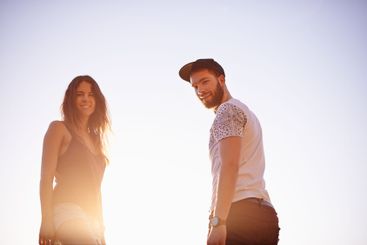Portrait, sky and couple with vacation, travel and...