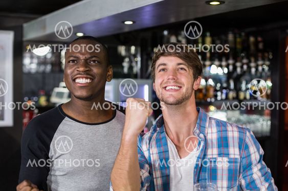 Happy friends watching sport