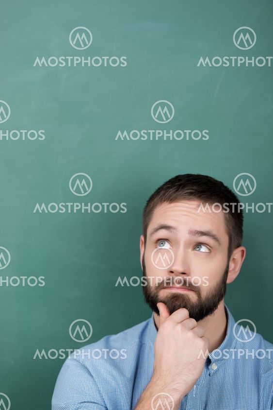 Professor Looking Up Against Chalkboard