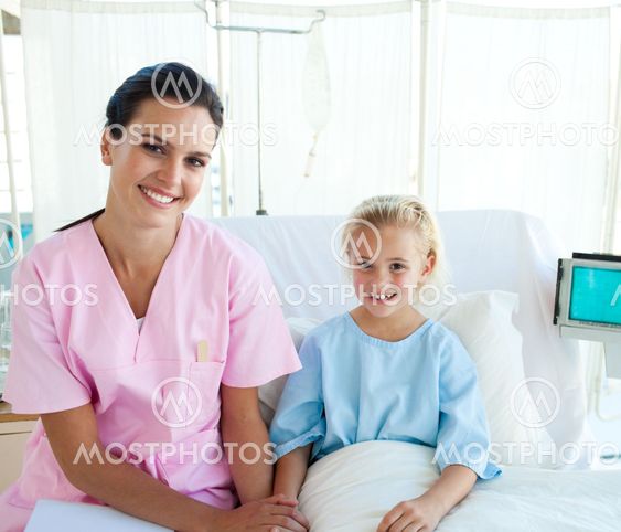 Female doctor with her little patient sitting on a hospital bed