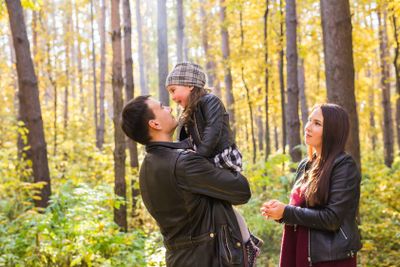 People, family and leisure concept - happy father holding...