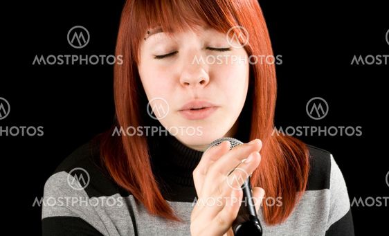 Girl singing karaoke on microphone