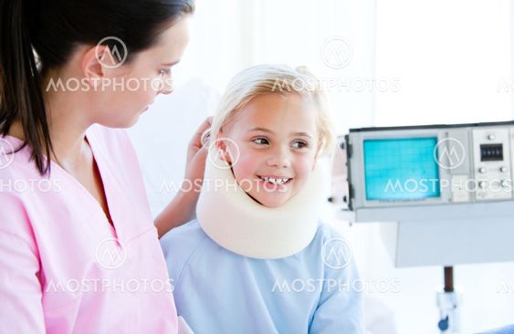 Adorable little girl with a neck brace sitting with her nurse