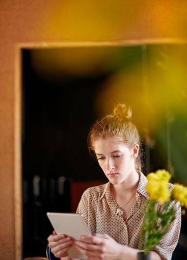 Tablet, reading and woman in cafe with remote work,...