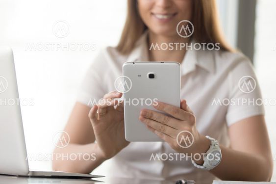 Close up image of digital tablet in womans hands