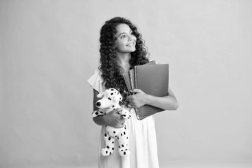 Funny school girl with toy. Happy childhood and kids...