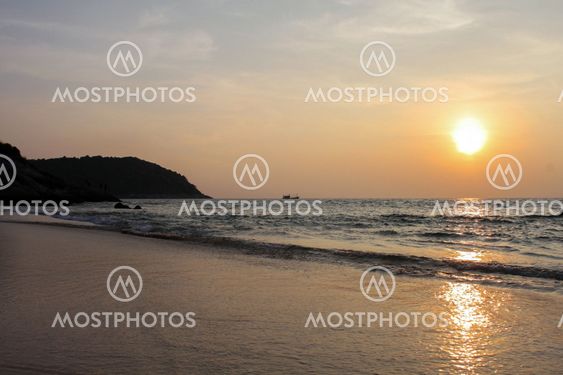 silhouette rocks at sunset on the seashore or beach