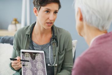 Woman, doctor and brain scan with tablet, xray and MRI...
